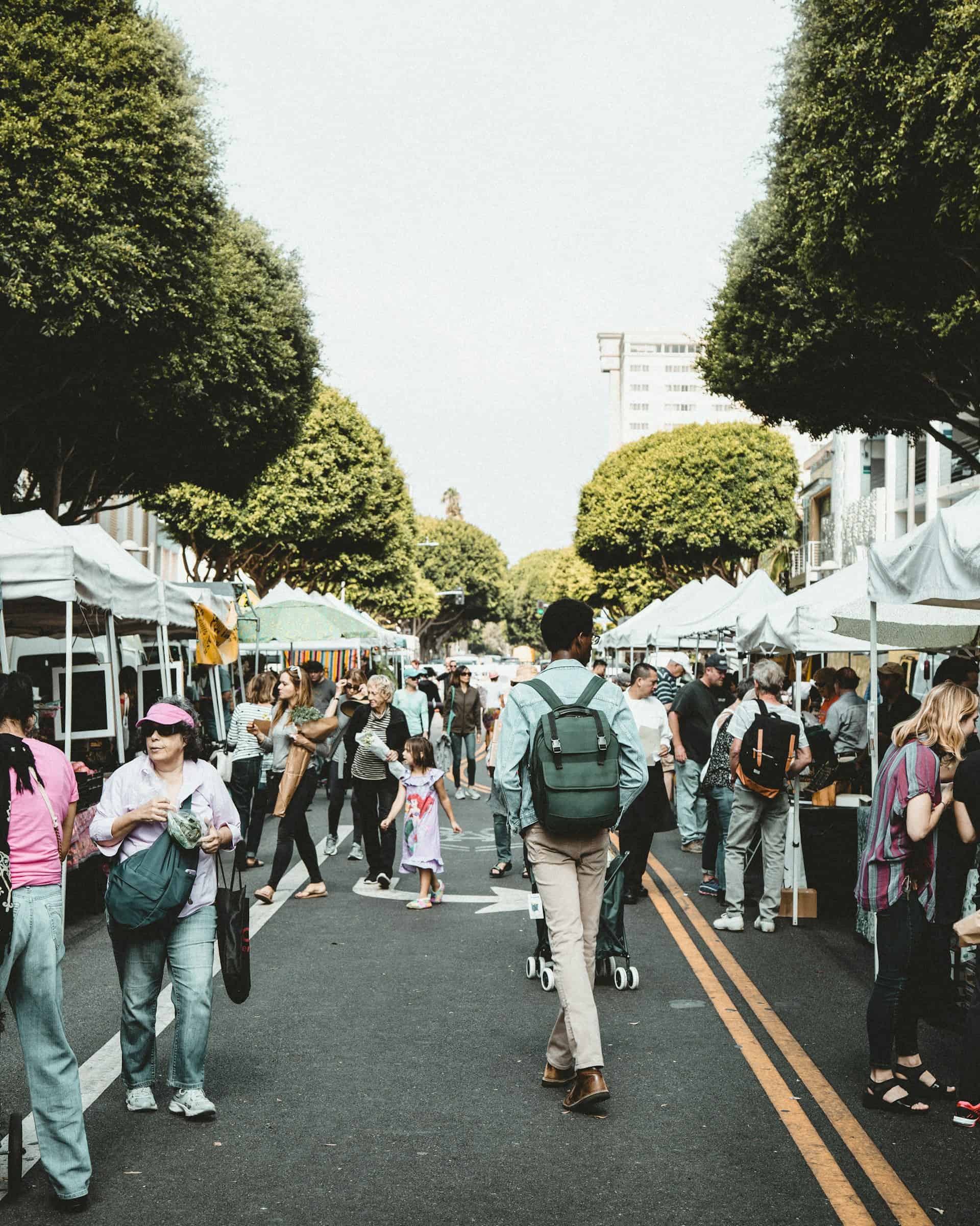 People walking through a vibrant farmer's market